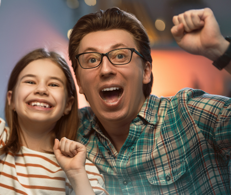 A young girl and a man cheering